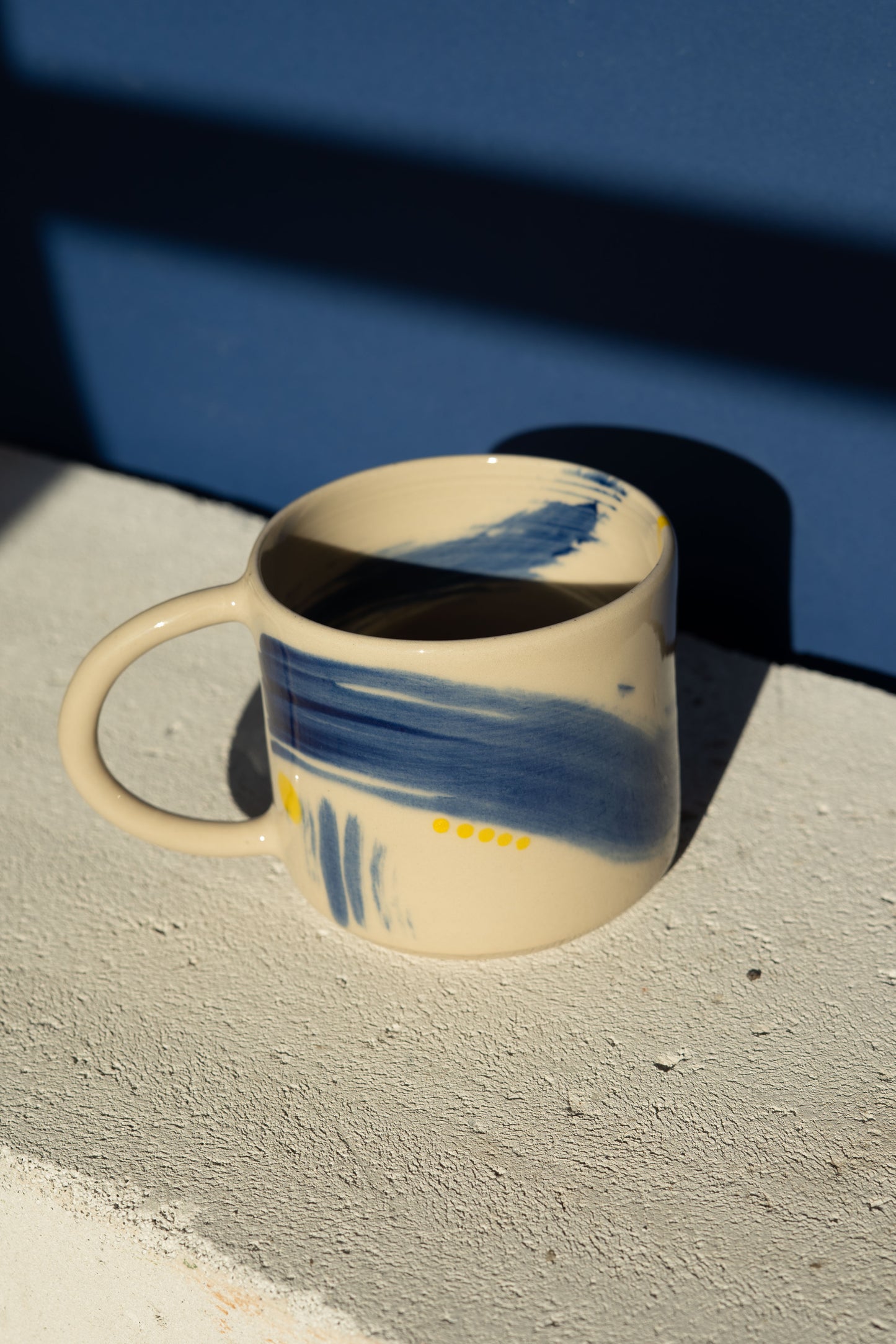 Large mug with blue stripe and yellow details