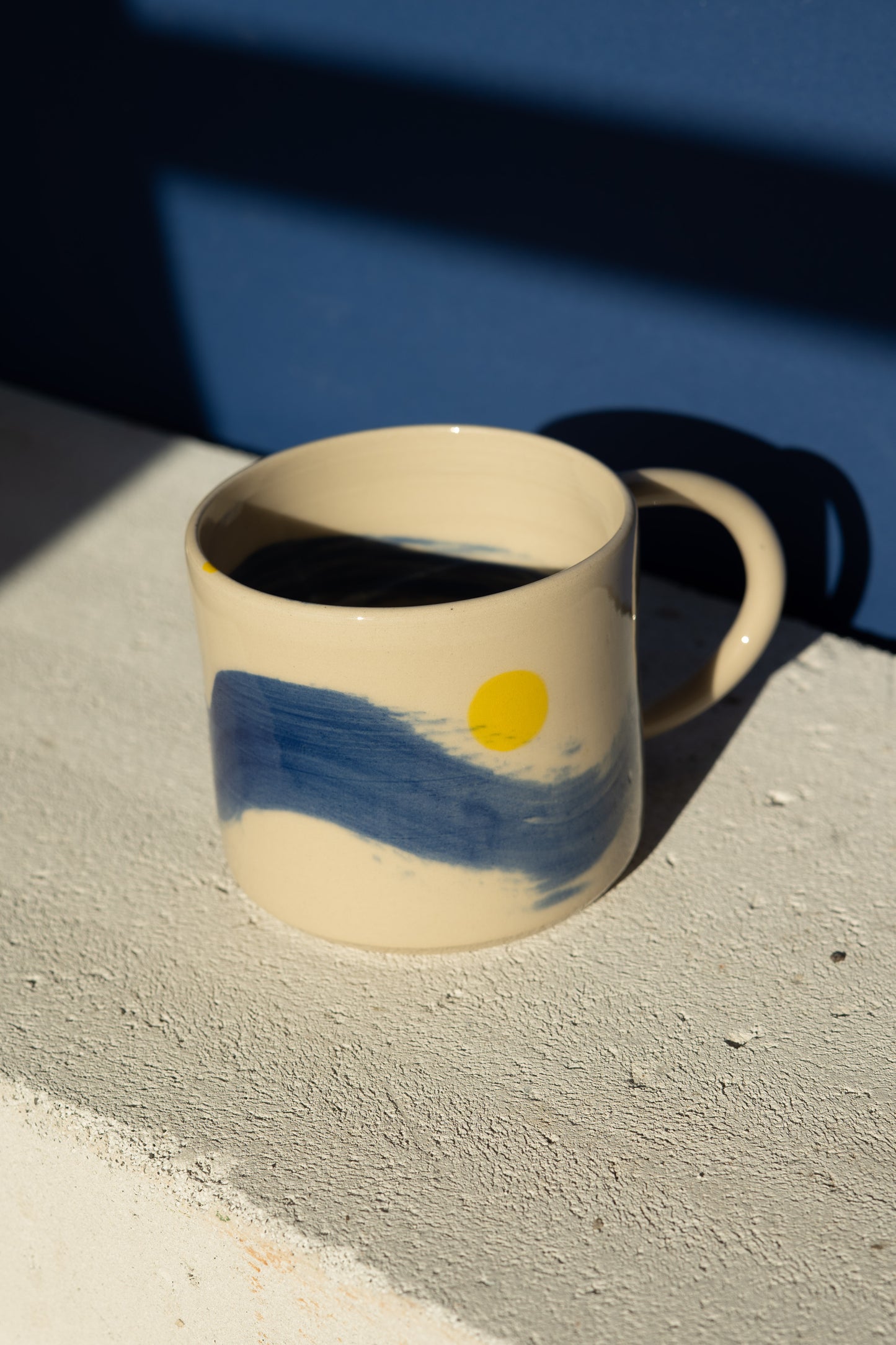 Large mug with blue stripe and yellow details