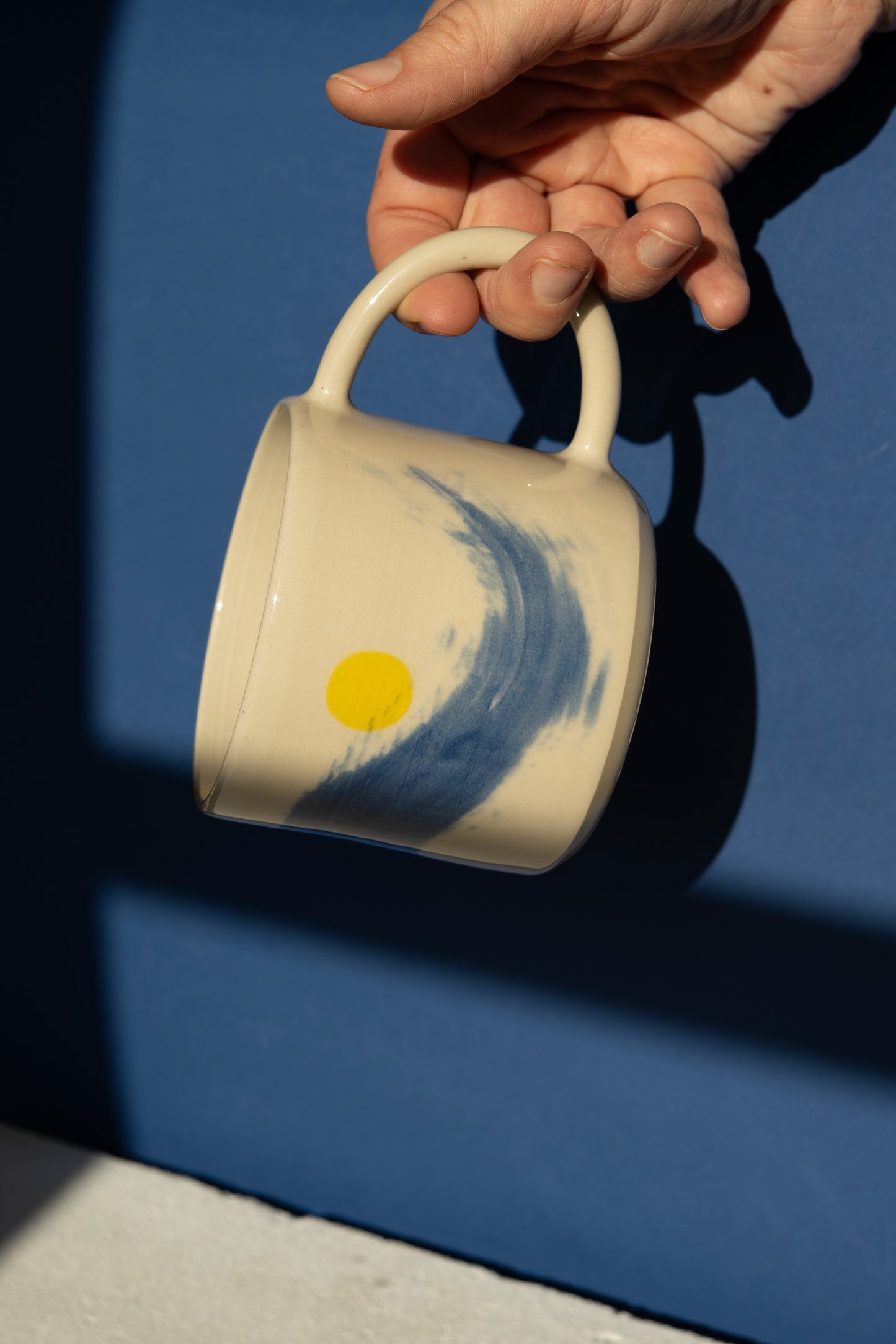 Large mug with blue stripe and yellow details