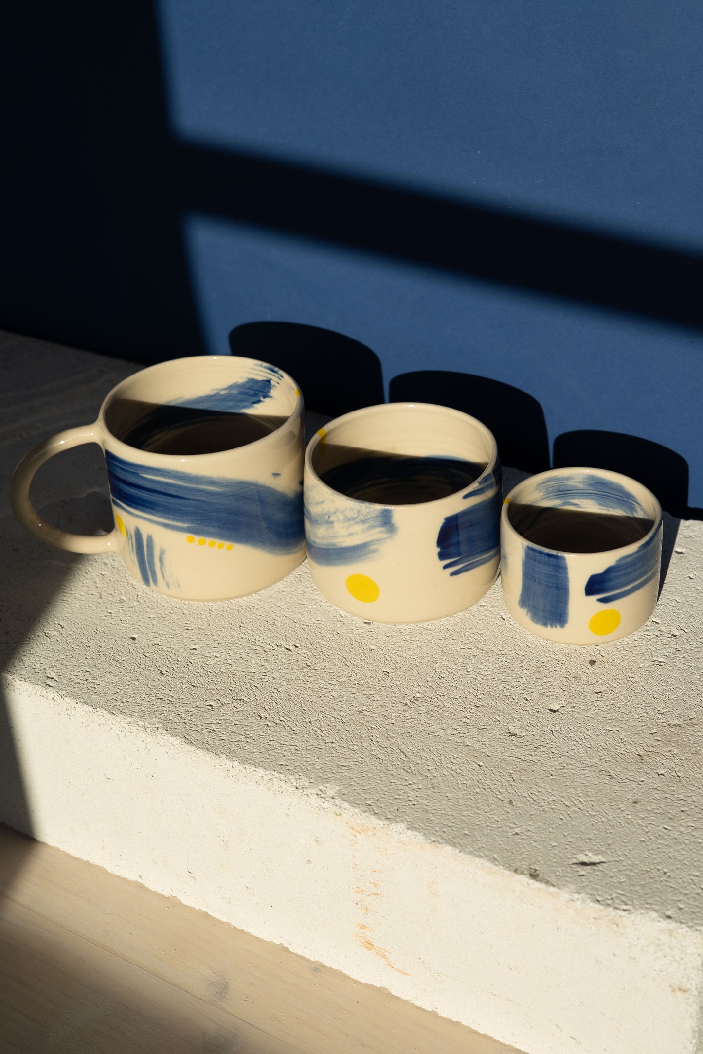 Large mug with blue stripe and yellow details