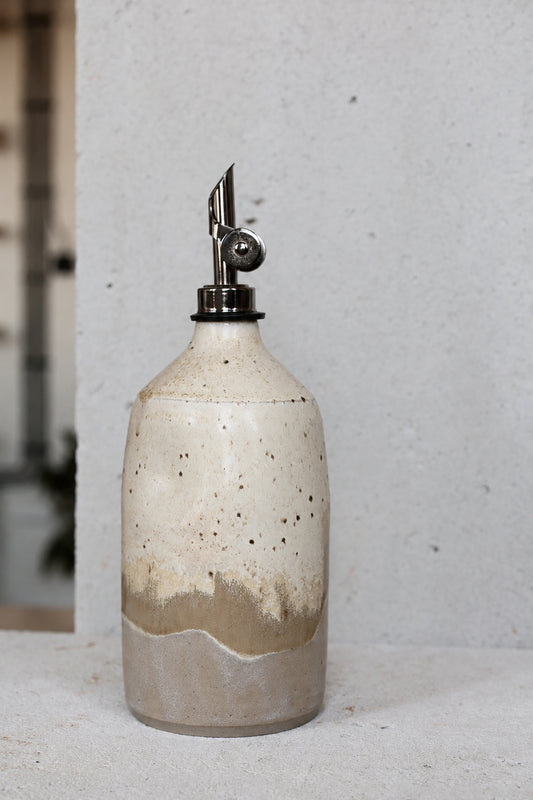 Ceramic oil bottle in light sand